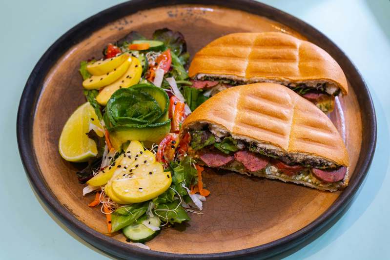 Team testing a stainless steel panini press on a kitchen counter